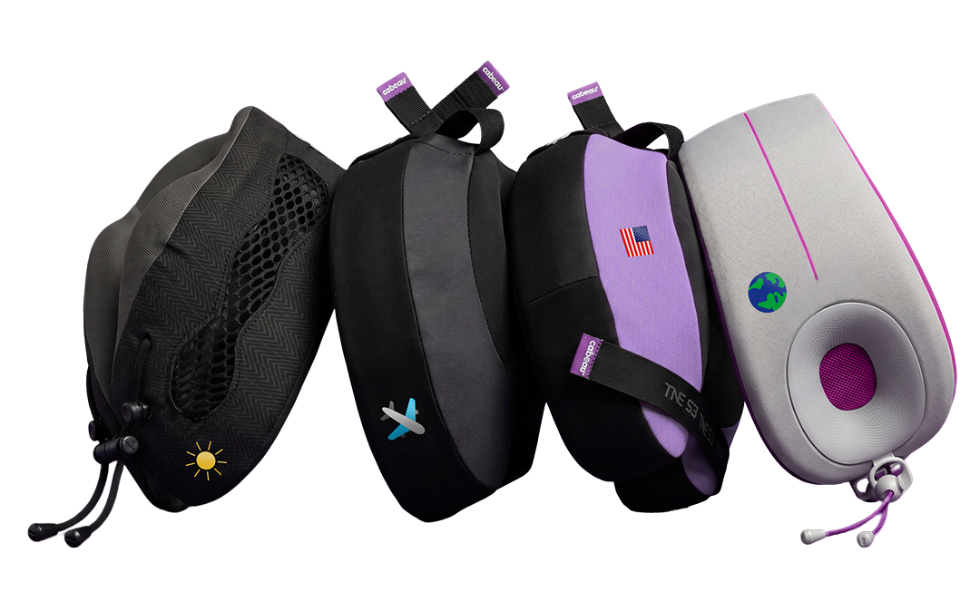 Four travel neck pillows in different colorways (black, dark gray, lavender, and gray with pink accents) arranged in a row on a plain white background with personalized icons