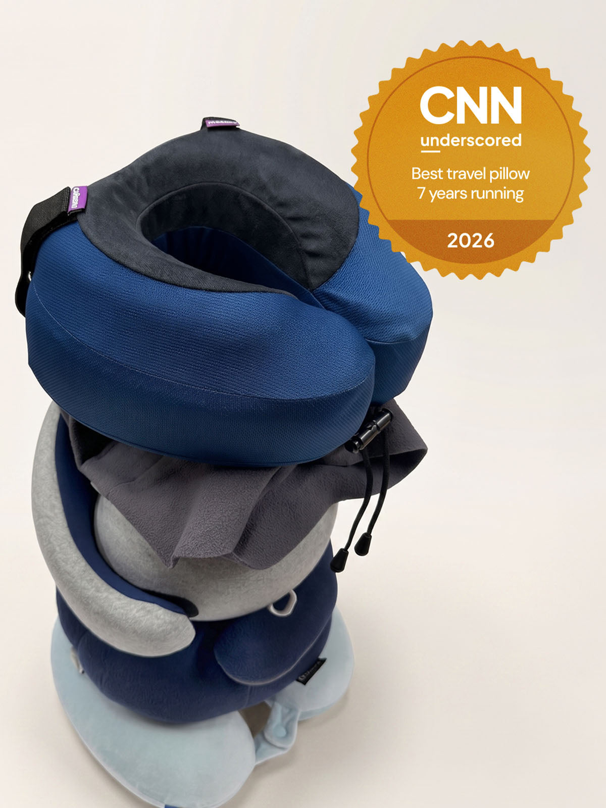 Blue travel pillow with CNN award on a white background