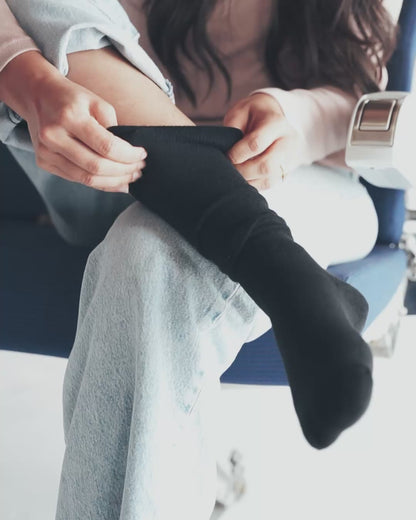 Woman wearing bamboo compression socks on flight