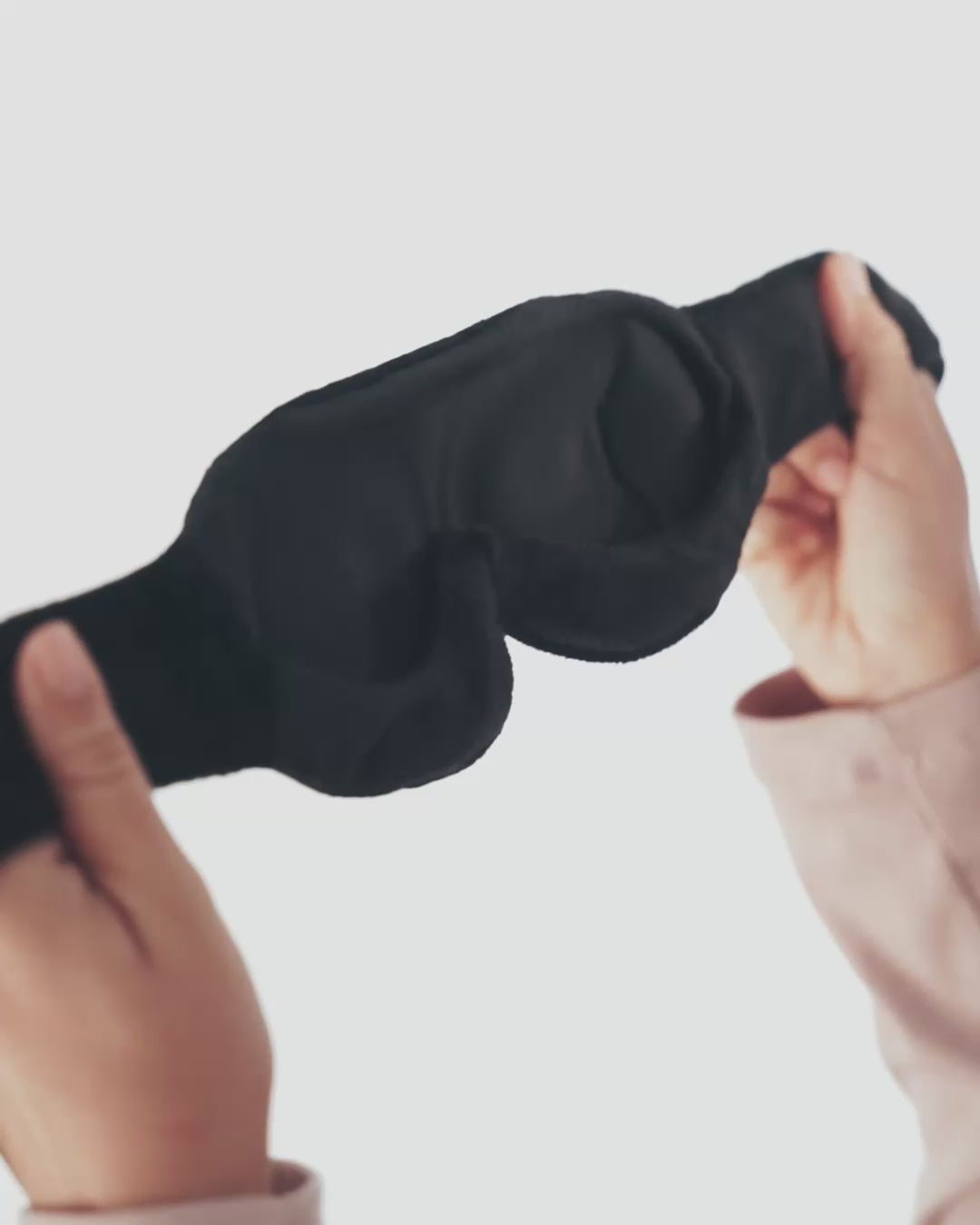 Showing domed eyeliners with traveler wearing the mask and adjusting nose bridge